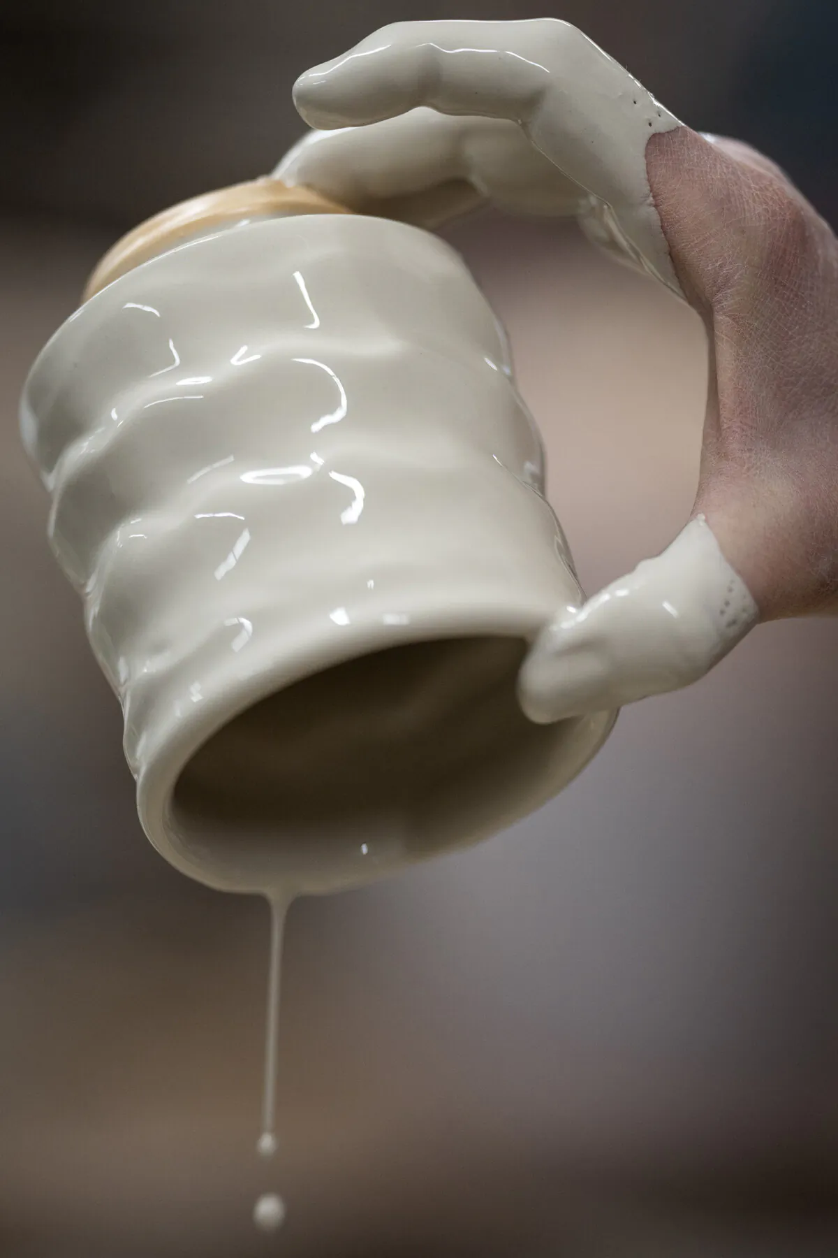 Studio manager Betsy Price applies glaze to a cup at Clay Coyote in Hutchinson, Minnesota, Friday, Jan. 26, 2024. (Leila Navidi/Minneapolis Star Tribune/TNS)