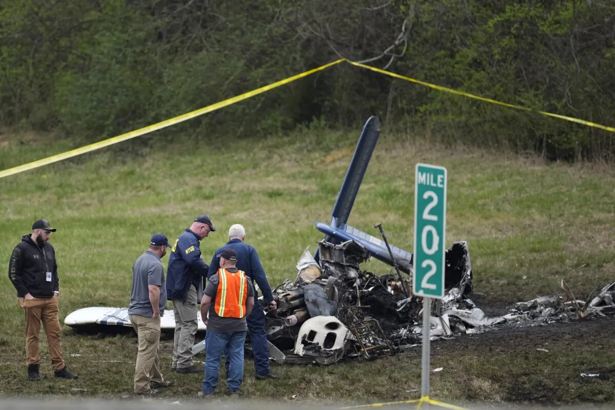 Investigators look over a small plane crash alongside eastbound Interstate 40 at mile marker 202 in Nashville, Tenn., on March 5, 2024. (George Walker IV/AP Photo)