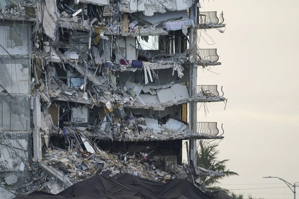 A giant tarp (bottom) covers a section of rubble at the Champlain Towers South condo building in Surfside, Fla., on July 4, 2021. (Lynne Sladky/AP Photo)