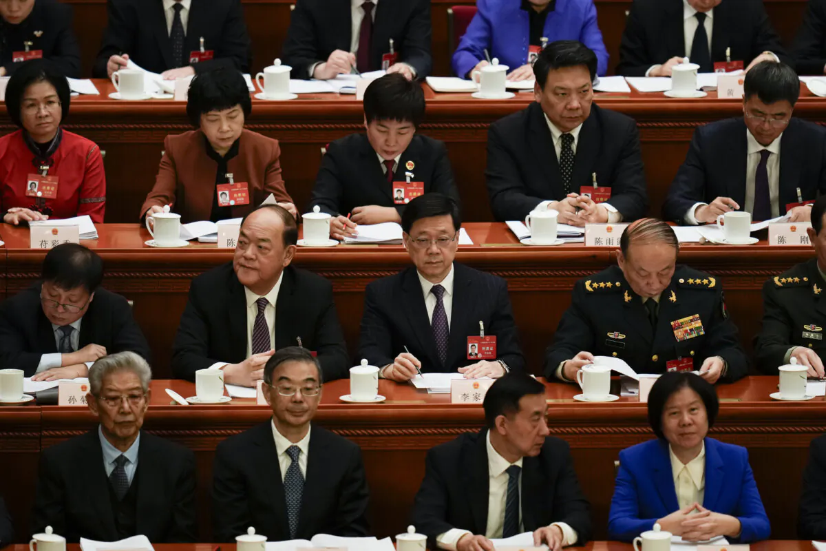 Hong Kong Chief Executive John Lee (C) attends the opening session of the National People's Congress (NPC) in Beijing, China, on March 5, 2024. (Ng Han Guan/AP Photo)