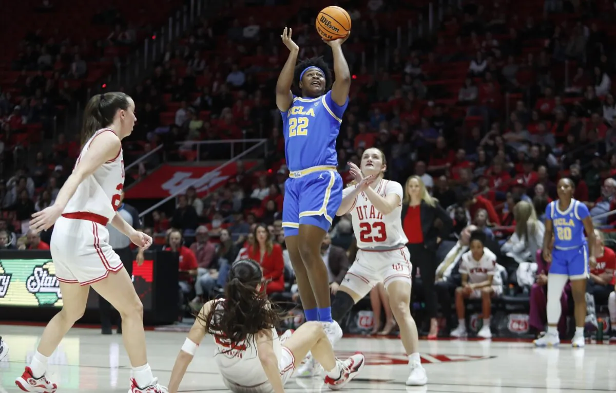 Christeen Iwuala (22) of the UCLA Bruins shoots over Kennady McQueen (24), Jenna Johnson (22) and Matyson Wilke (23) of the Utah Utes during the first half of their game at Jon M Huntsman Center in Salt Lake City on Jan. 22, 2024. (Chris Gardner/Getty Images)
