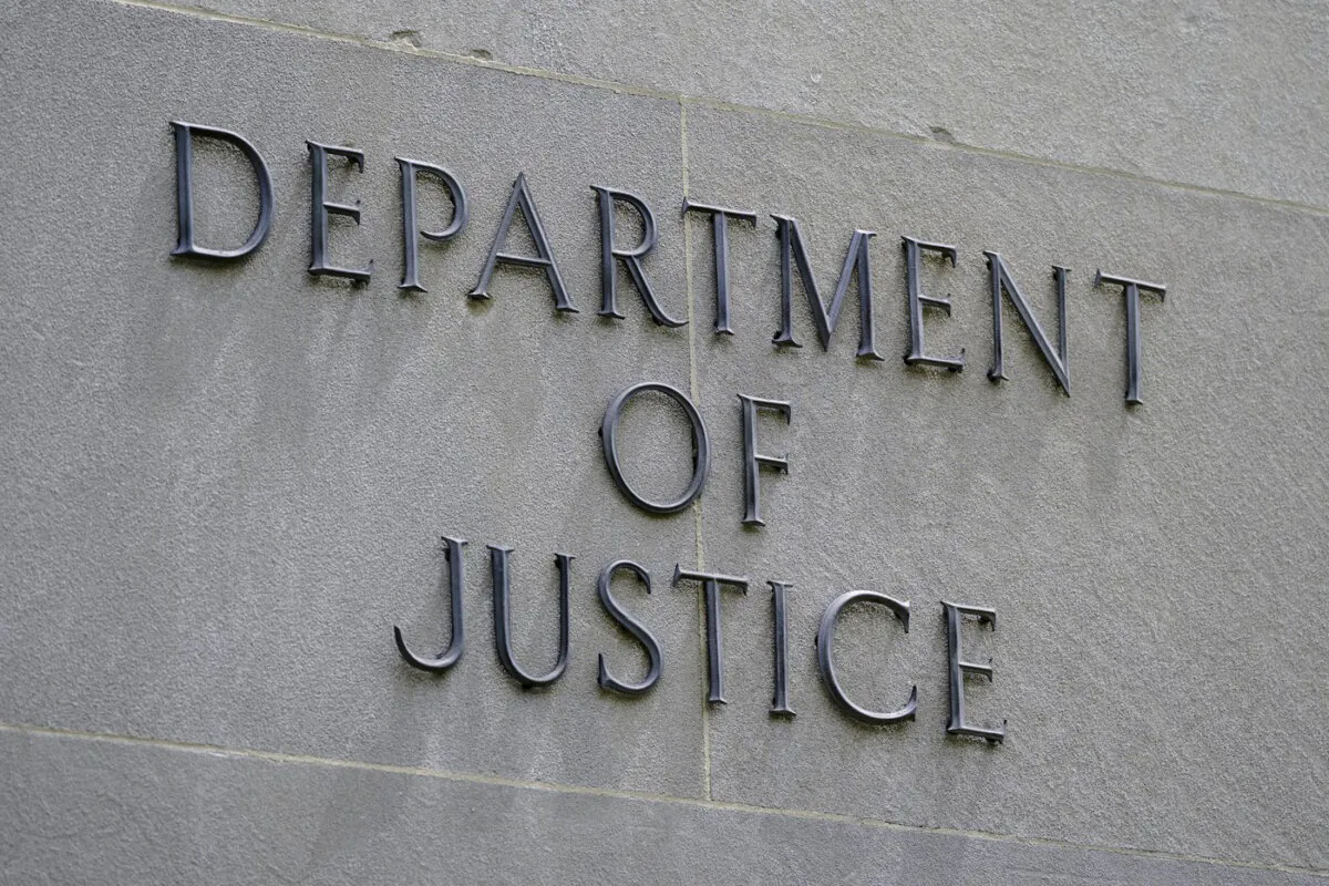 A sign on the exterior of the Robert F. Kennedy Department of Justice building in Washington on May 4, 2021. (Patrick Semansky/The Canadian Press/AP)