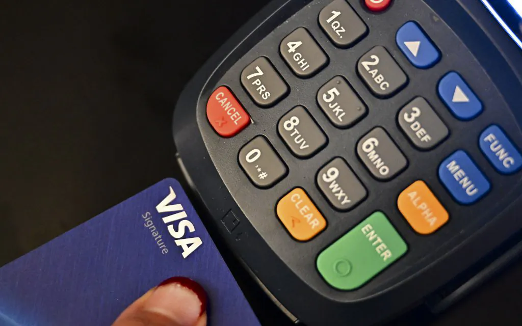 A credit card is placed into a credit card machine for processing payments in La Puente, Calif., on Sept. 11, 2023. (Frederic J. Brown/AFP via Getty Images)
