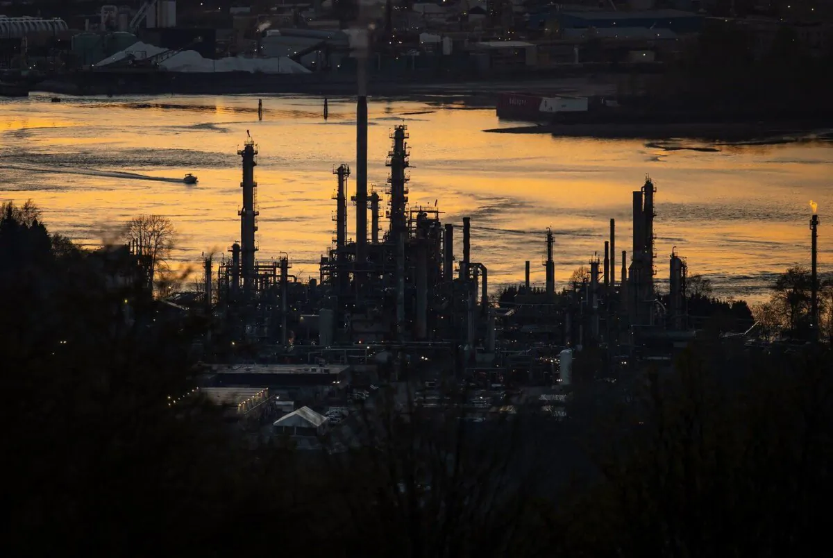 A boat travels past the Parkland Burnaby Refinery on Burrard Inlet at sunset in Burnaby, B.C., on April 17, 2021. (The Canadian Press/Darryl Dyck)
