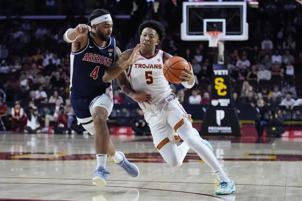 Southern California guard Boogie Ellis (5) is defended by Arizona guard Kylan Boswell (4) during the first half of an NCAA college basketball game in Los Angeles on March 9, 2024. (Marcio Jose Sanchez/AP Photo)