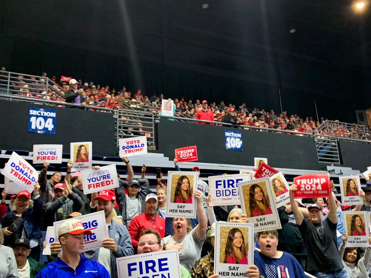 Trump supporters hold up signs featuring Laken Riley at a rally in Rome, Ga., on March 9, 2024. (T.J. Muscaro/The Epoch Times)