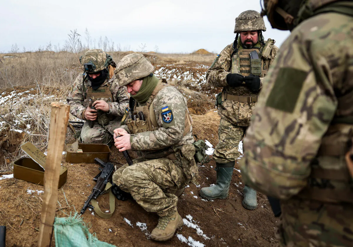 Ukrainian servicemen prepare their weapons during a military training exercise near the front line in the Donetsk region in Ukraine on Feb. 23, 2024. (Anatolii Stepanov/AFP via Getty Images)