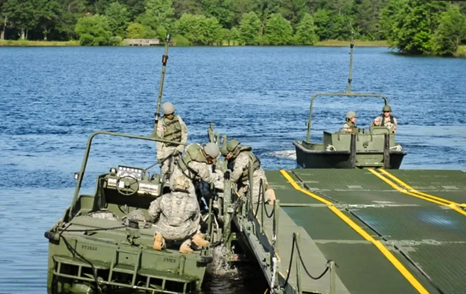 U.S. Soldiers with the 299th Engineer Company from Fort Belvoir, Va., under the 463rd Engineer Battalion, 411th Engineer Brigade, secure an MK2 Bridge Erection Boat to the side of an Improved Ribbon Bridge Raft on Big Sandy Lake at Fort McCoy, Wis., on July 17, 2013. (Sgt. Francis Horton, U.S. Army)