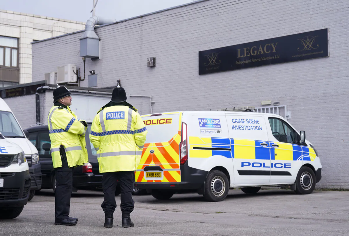Police stand outside the Hessle Road branch  of Legacy Independent Funeral Directors in Hull, England, on March 9, 2024. (Danny Lawson/PA via AP)