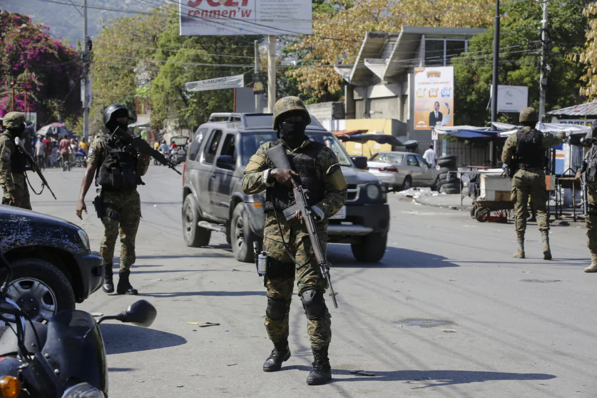 Members of the General Security Unit of the National Palace set up a security perimeter around one of the three downtown stations after police fought off an attack by gangs the day before, in Port-au-Prince, Haiti, on March 9, 2024. (Odelyn Joseph/AP Photo)