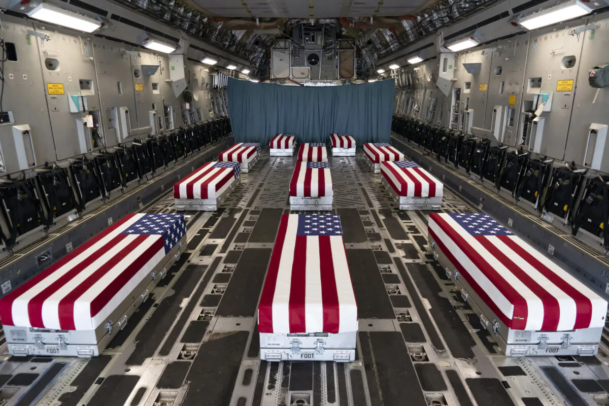 Flag-draped transfer cases line the inside of a C-17 Globemaster II on Aug. 29, 2021, prior to a dignified transfer at Dover Air Force Base, Del. The fallen servicemembers died while supporting non-combat operations in Kabul, Afghanistan. (U.S. Air Force photo by Jason Minto)