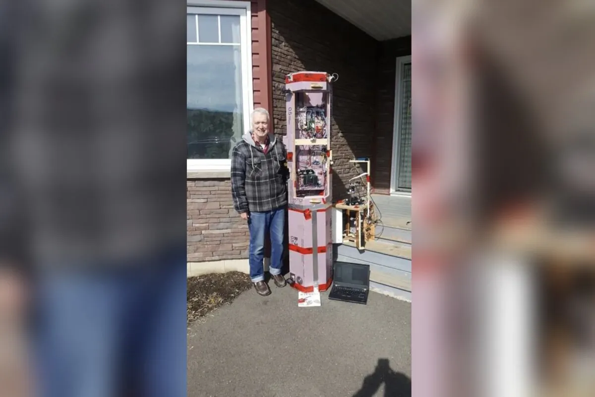 David Hunter poses with the payload for the Balloon Solar Eclipse Project in Florenceville-Bristol, N.B., on Mar. 4. (The Canadian Press/David Hunter, Balloon Solar Eclipse Project)
