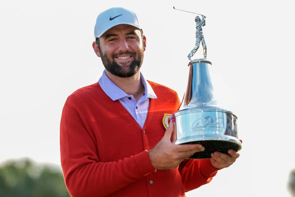 Scottie Scheffler holds the championship trophy after winning the Arnold Palmer Invitational golf tournament in Orlando, Fla., on March 10, 2024. (John Raoux/AP Photo)