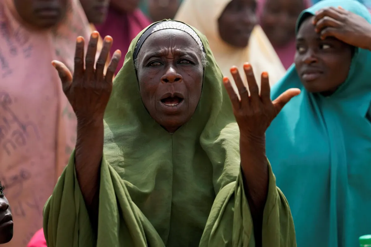 A woman prays for the kidnapped LEA Primary and Secondary School students in Kuriga, Kaduna state Nigeria, on March 9, 2024. (Sunday Alamba/AP Photo)