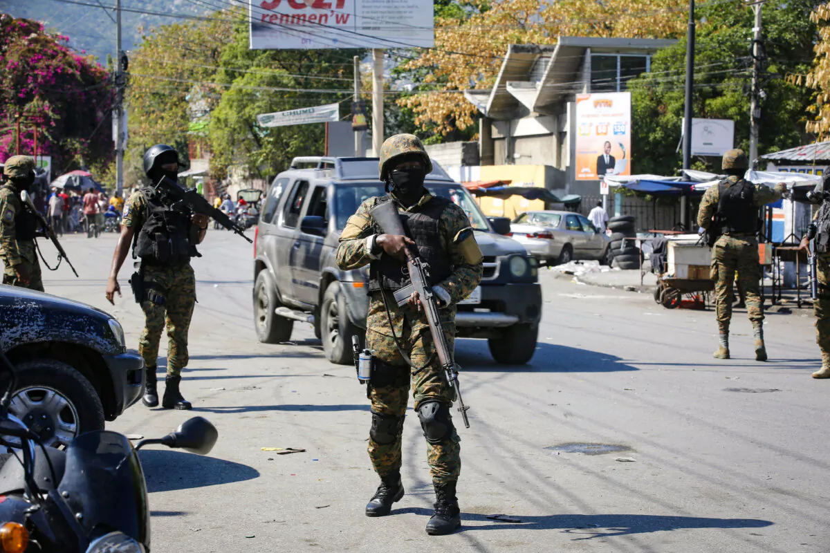 Members of the General Security Unit of the National Palace, USGPN, set up a security perimeter around one of the three downtown stations after police fought off an attack by gangs the day before, in Port-au-Prince, Haiti, on Mar. 9, 2024. (Odelyn Joseph/AP Photo)