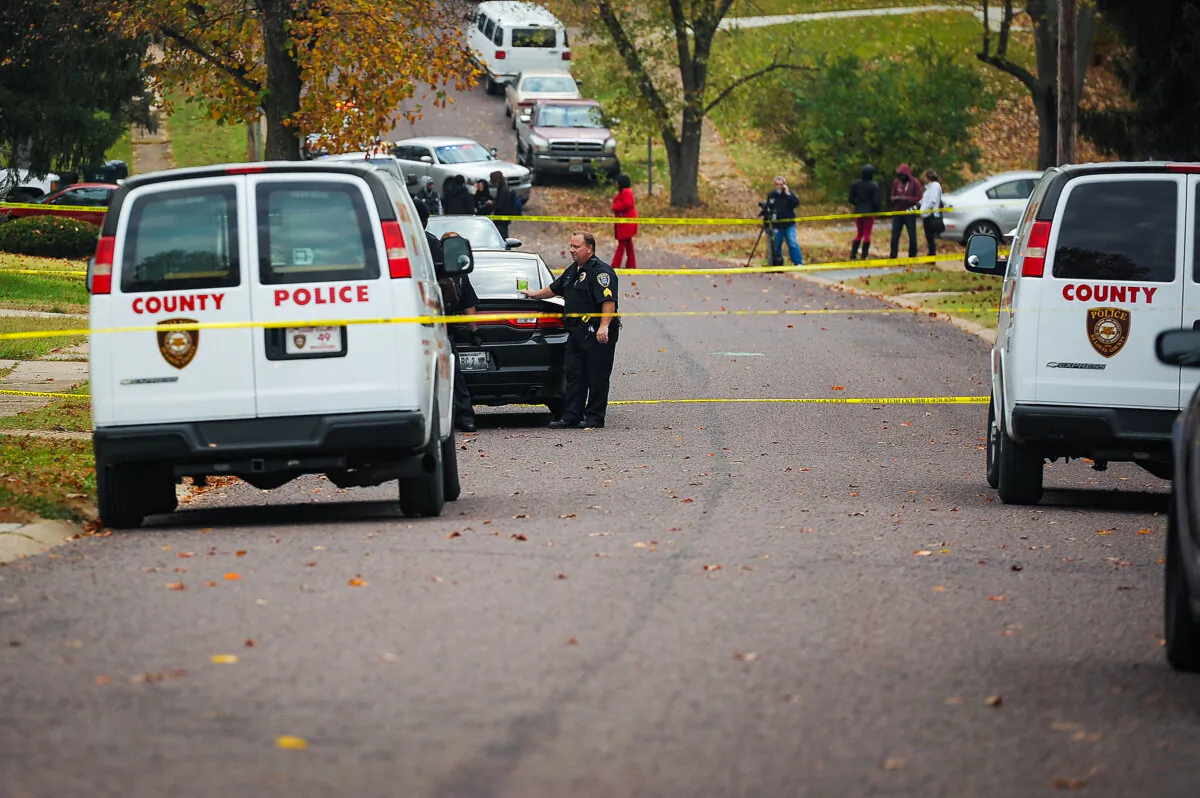 Police officers stand within a crime scene perimeter in Normandy, Mo., on Oct. 28, 2015. (Michael B. Thomas/Getty Images)