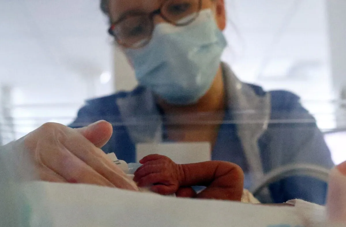 Neonatal nurse Layla Bridges cares for a premature baby in the Neonatal Intensive Care Unit at the Lancashire Women and Newborn Centre at Burnley General Hospital, northwest England, on May 15, 2020. (Hannah McKay/POOL/AFP via Getty Images)