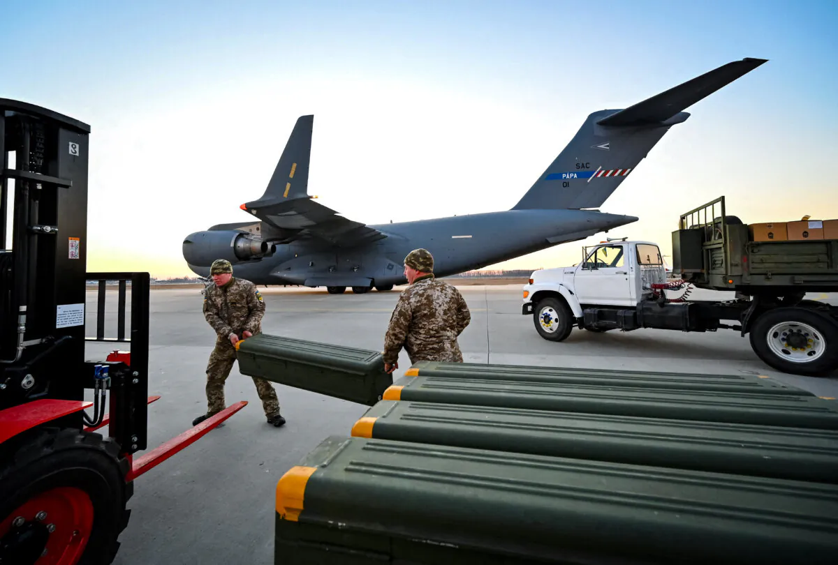 Ukrainian military forces move U.S.-made military equipment and other military assistance shipped from Lithuania to Boryspil Airport in Kyiv, Ukraine, on Feb. 13, 2022. (Sergei Supinsky/AFP via Getty Images)