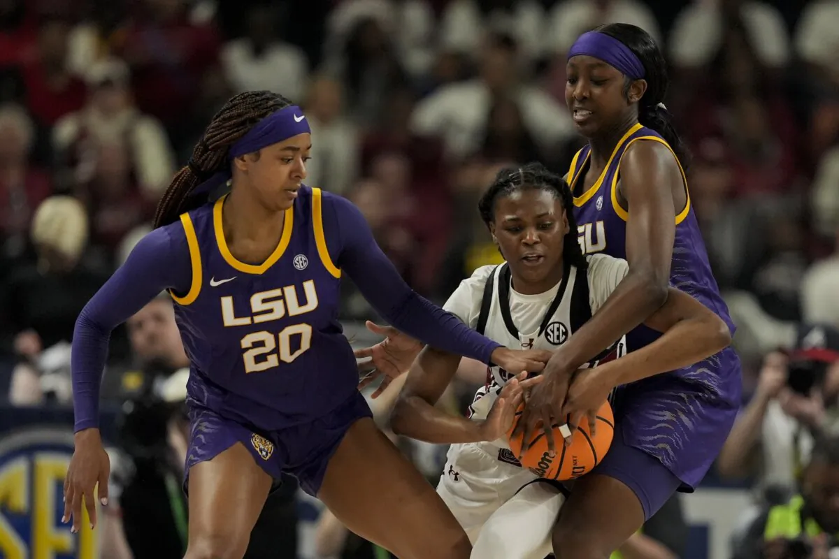 South Carolina guard MiLaysia Fulwiley vies for the ball with LSU guard Janae Kent (L) and guard Flau'jae Johnson during the first half of an NCAA college basketball game at the Southeastern Conference women's tournament final in Greenville, S.C., on March 10, 2024. (Chris Carlson/AP Photo)