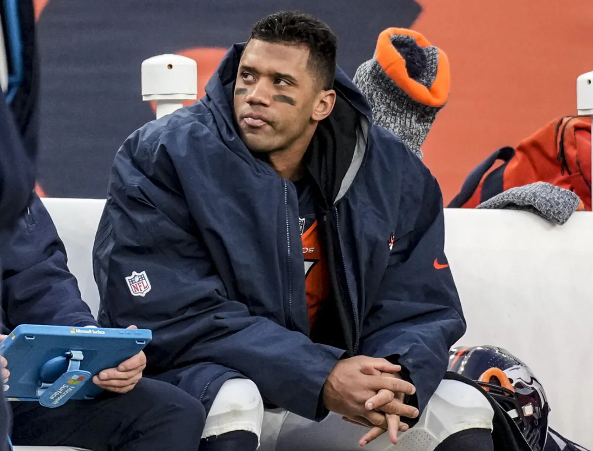 Denver Broncos quarterback Russell Wilson sits on the bench during the second half of an NFL football game against the Los Angeles Chargers in Denver on Dec. 31, 2023. (David Zalubowski/AP Photo)