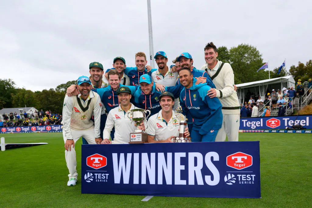 Captain Pat Cummins of Australia (C) and his team mates pose with the trophy after their series win during day four of the Second Test in the series between New Zealand and Australia at Hagley Oval in Christchurch, Wellington on March 11, 2024. (Kai Schwoerer/Getty Images)