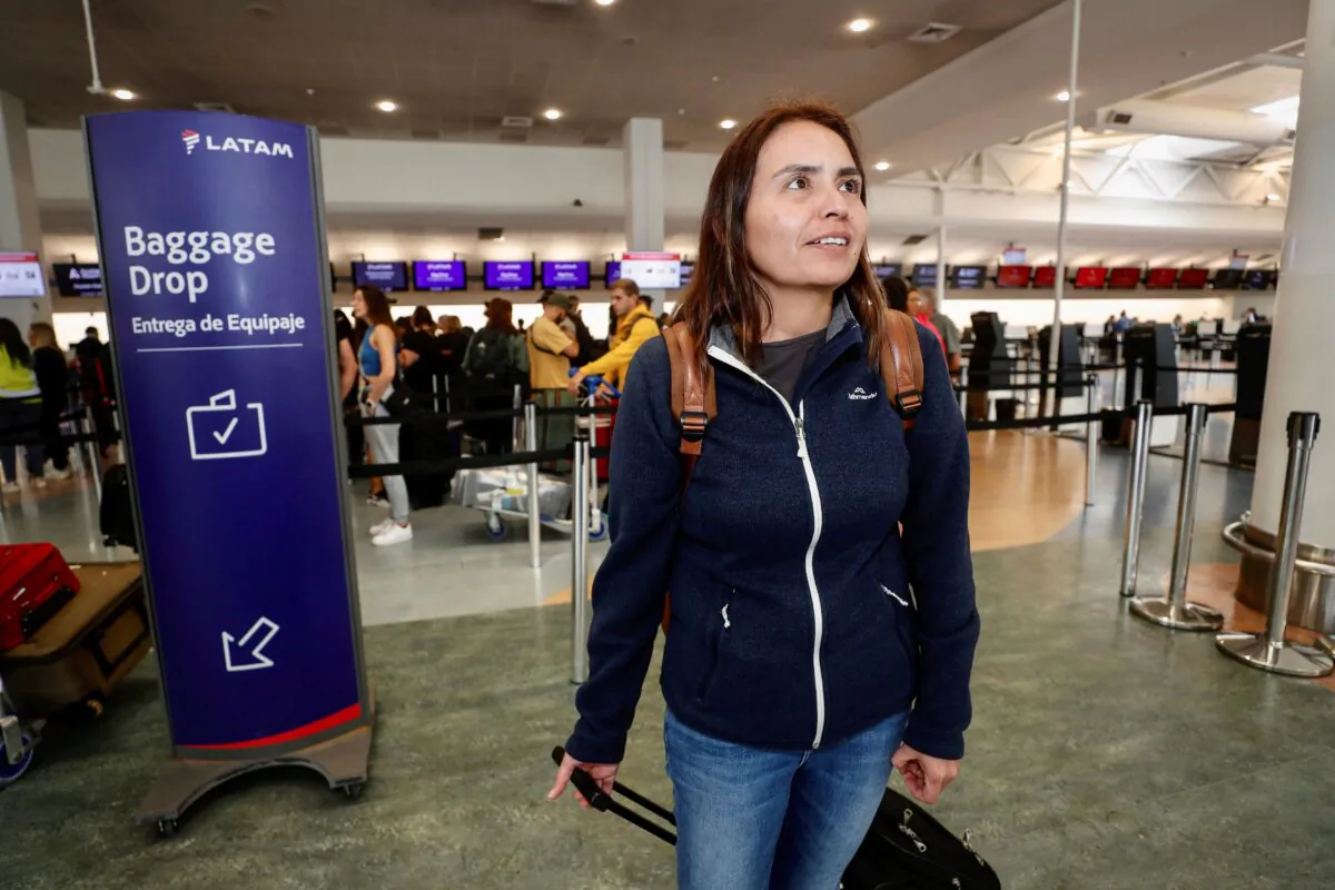 Passenger Janet Baker prepares to check in at Auckland, New Zealand airport for a LATAM Airlines flight to Santiago, Chile, on March 12, 2024. (Dean Purcell/New Zealand Herald via AP)