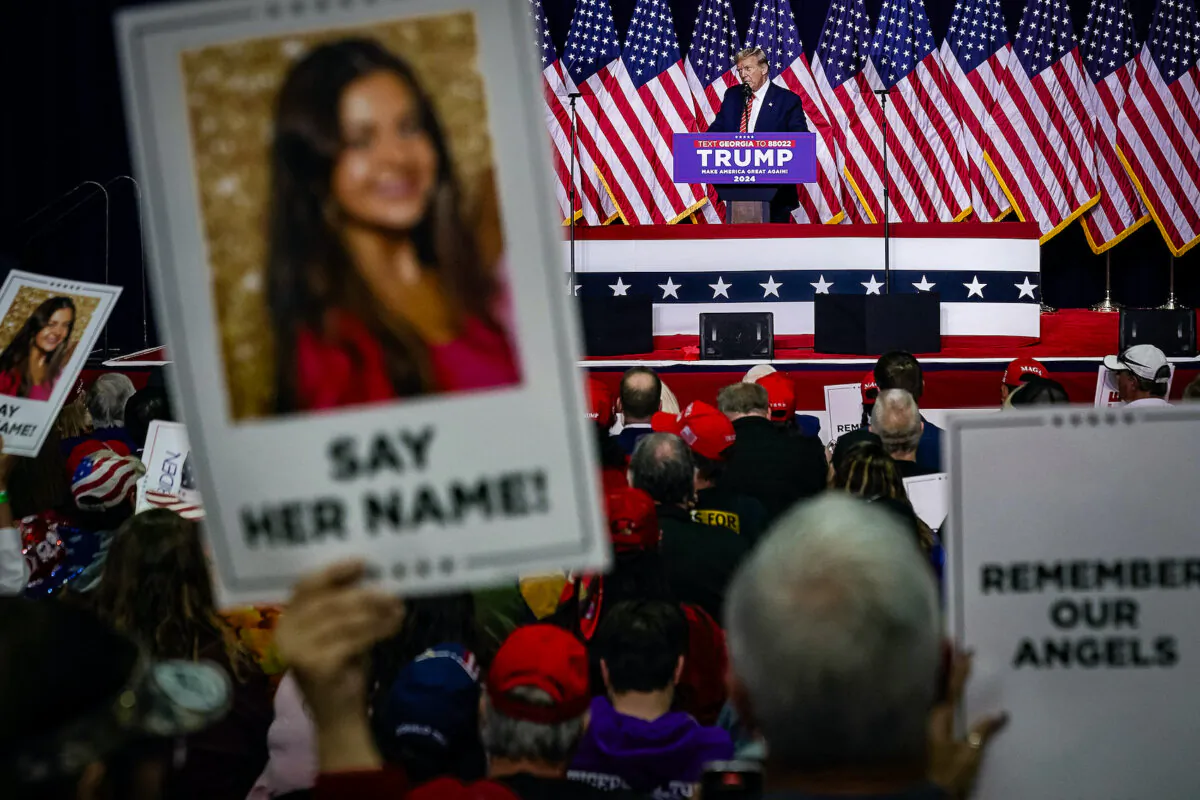 Former President and 2024 presidential hopeful Donald Trump speaks as supporters hold images of Laken Riley during a campaign event in Rome, Ga., on March 9, 2024. (Elijah Nouvelage/AFP via Getty Images)