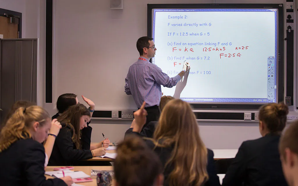 A teacher talks to pupils during a maths lesson at the Ridings Federation Winterbourne International Academy in Winterbourne, England, on Feb. 26, 2015. (Matt Cardy/Getty Images)