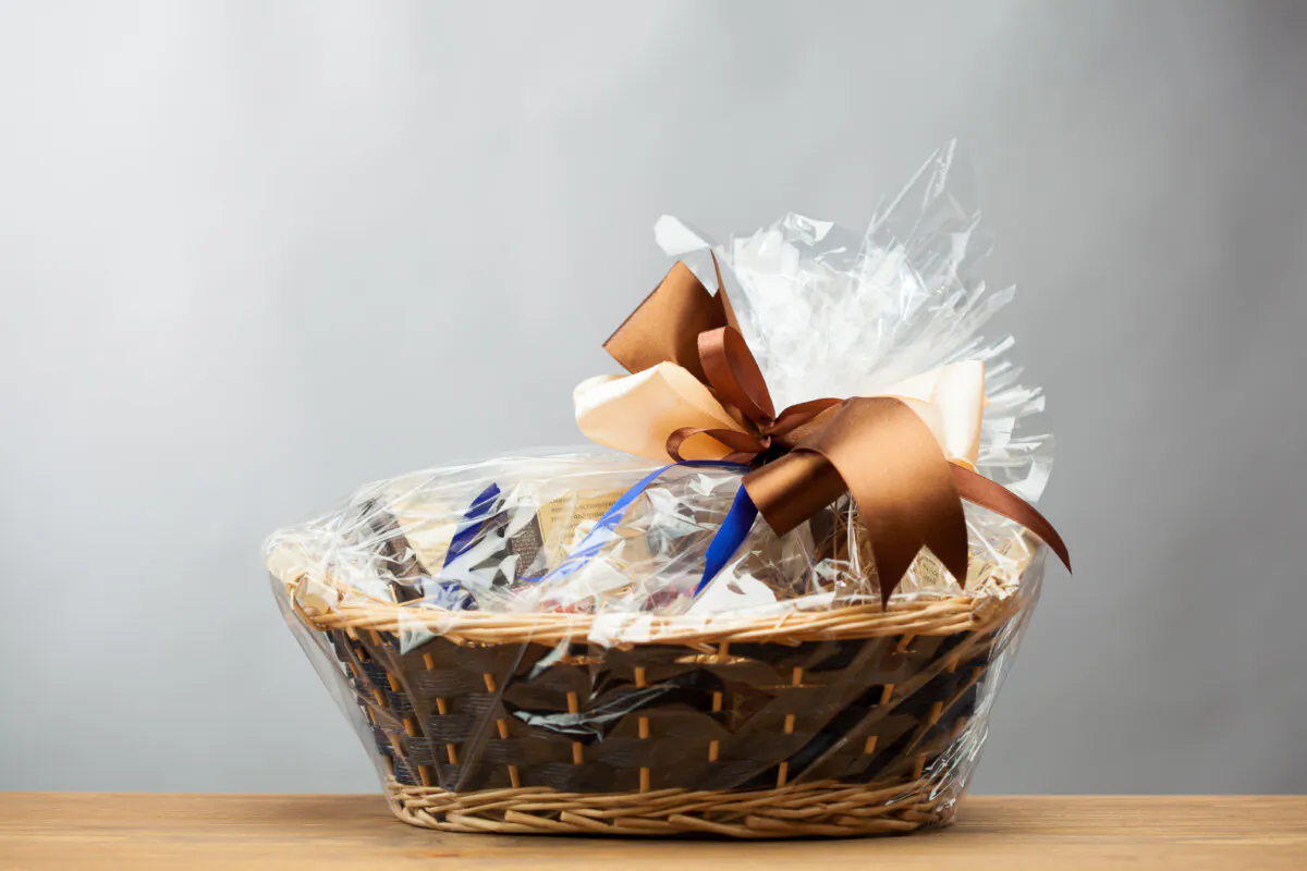 A gift basket with a cookbook as its centerpiece. (nikkytok/Shutterstock)