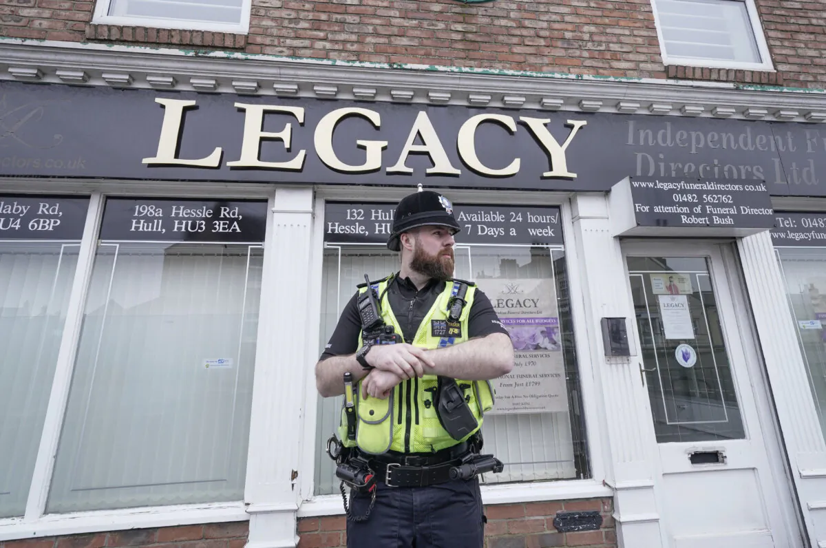 A police officer outside the Beckside branch of Legacy Independent Funeral Directors in Hull, England, on March 9, 2024. (Danny Lawson/PA Wire)