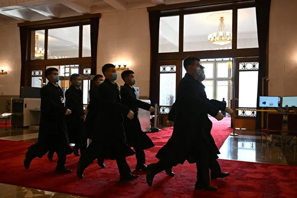 Security members walk past an entrance during the closing ceremony of the Chinese People's Political Consultative Conference (CPPCC) at the Great Hall of the People in Beijing on March 10, 2024. (Jade Gao / AFP)