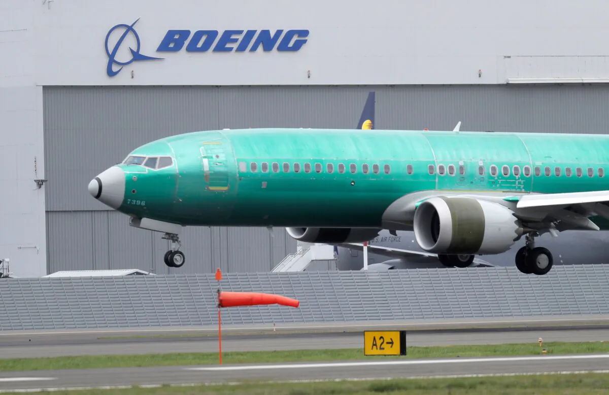 A Boeing 737 Max 8 airplane lands following a test flight at Boeing Field in Seattle in April 10, 2019. (Ted S. Warren/AP Photo)