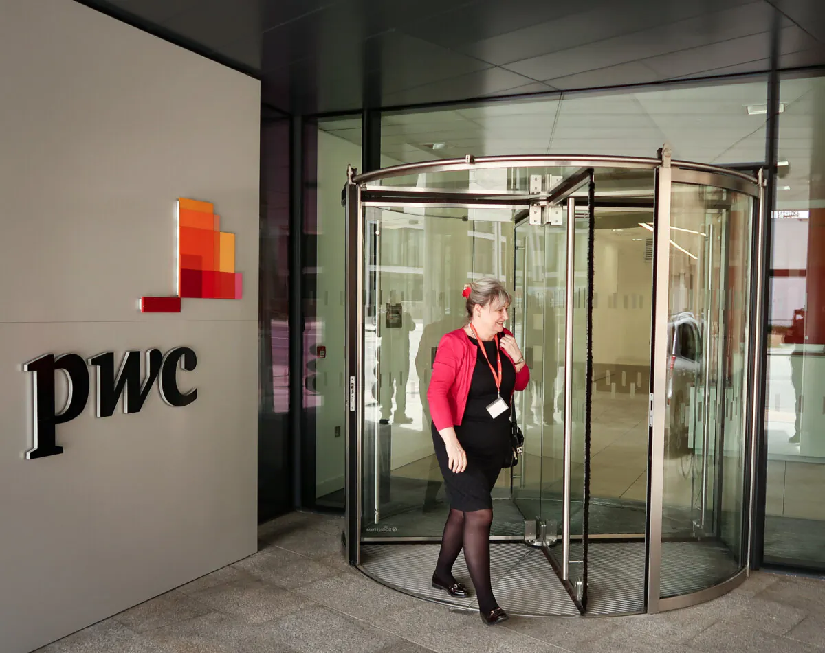 People pass the offices of PricewaterhouseCoopers in St Helier, Jersey, on April 12, 2017. (Matt Cardy/Getty Images)