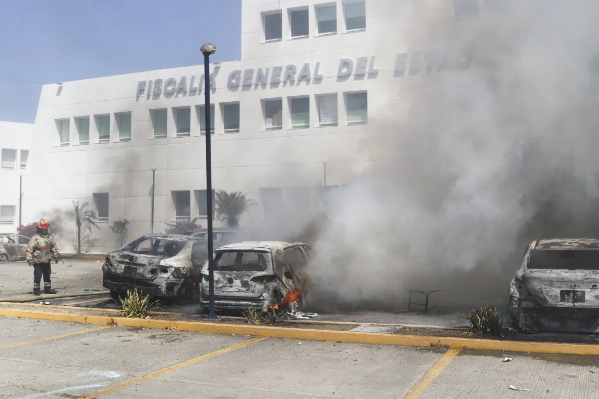 Cars burn at the state's Attorney General's Office after students set them on fire to protest the shooting of one of their colleagues during a confrontation with police in Chilpancingo, Mexico, on March 12, 2024. (Alejandrino Gonzalez/AP Photo)