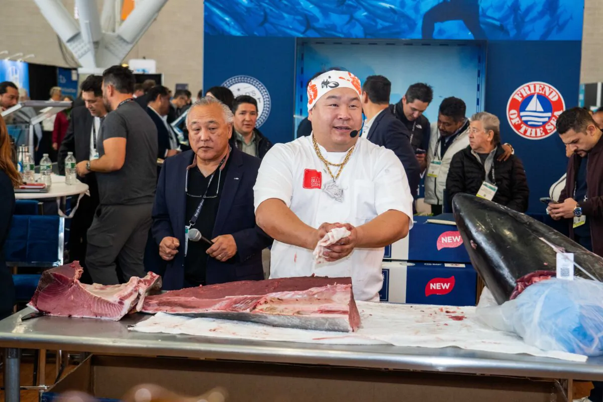 A chef cutting fish in the North America Seafood Expo in Boston on March 11, 2024. (Pearl Chang/The Epoch Times)