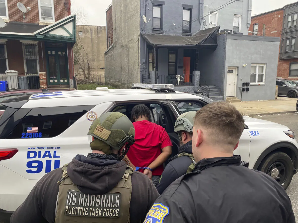 Members of law enforcement arrest an individual, in this file photo. (United States Marshals Service via AP)