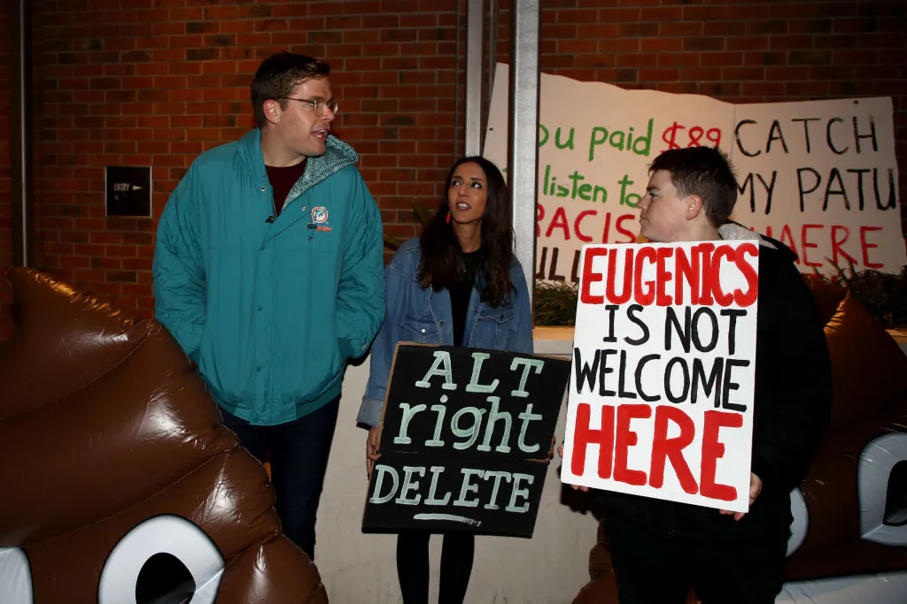 Television personality and comedian Guy Williams (L) and Green Party MP Golriz Ghahraman (C) join protestors outside the Pullman Hotel as Nigel Farage speaks on September 4, 2018 in Auckland, New Zealand. (Phil Walter/Getty Images)