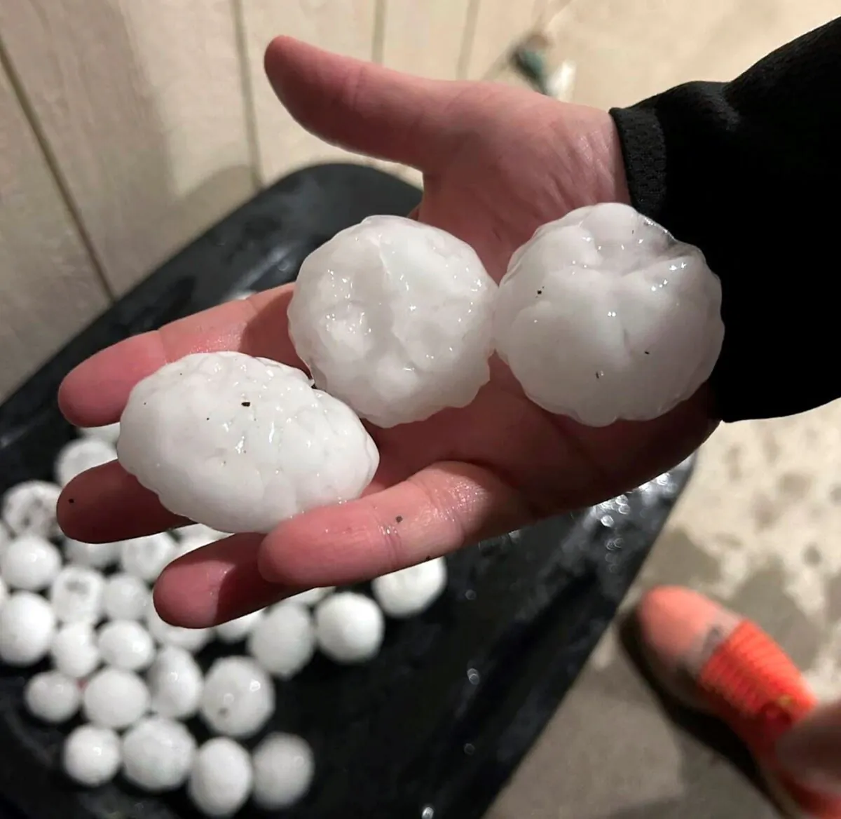 Large chunks of hail are shown, in Shawnee, Kan., on March 13, 2024. (Jeremy Crabtree via AP)