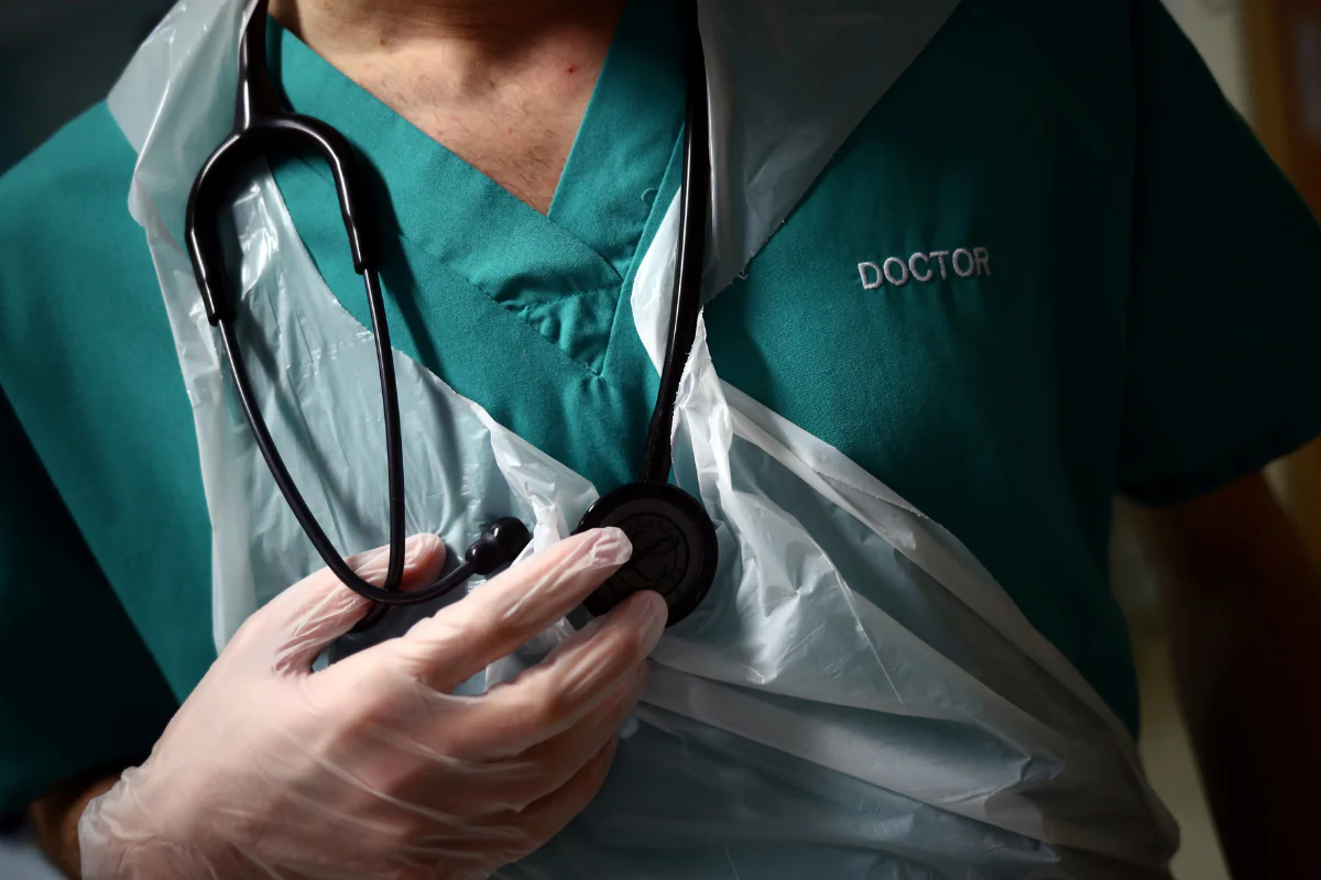File photo of a junior doctor holding his stethoscope at The Royal Blackburn Teaching Hospital in East Lancashire on May 17, 2020. (Hannah McKay/PA Wire)