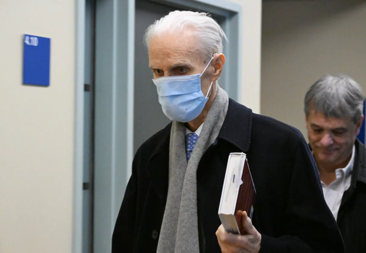Former Quebec Court of Appeal judge Jacques Delisle, centre, walks to the courtroom at the Hall of Justice in Quebec City, on March 14, 2024. (The Canadian Press/Jacques Boissinot)