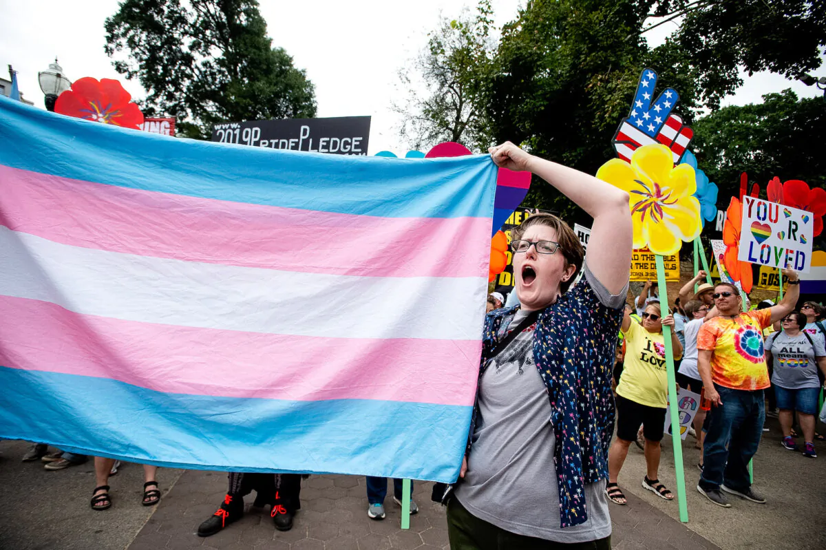 An activist on behalf of transgenderism holds up a flag at an event in Atlanta, Ga., on Oct. 12, 2019. (Robin Rayne/AP Photo)