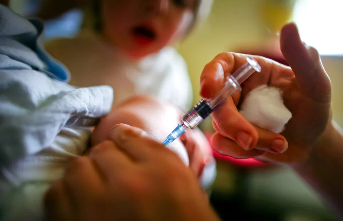 A young boy receives an immunization shot in a file photo. (Jeff J. Mitchell/Getty Images)