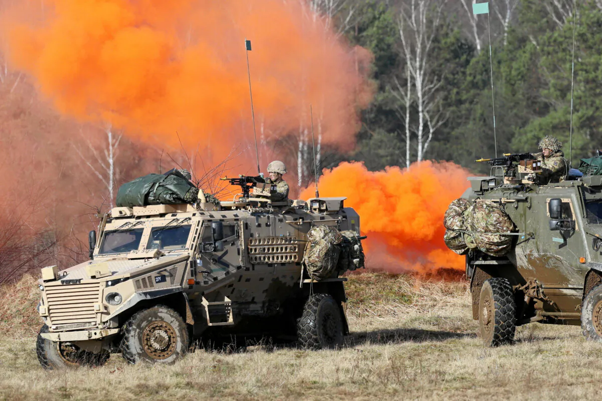 Soldiers sit in military vehicles during NATO's Steadfast Defender Brilliant Jump 2024 military exercise in Drawsko Pomorskie, Poland, on Feb. 26, 2024. (Cezary Aszkielowicz/Agencja Wyborcza.pl via REUTERS)