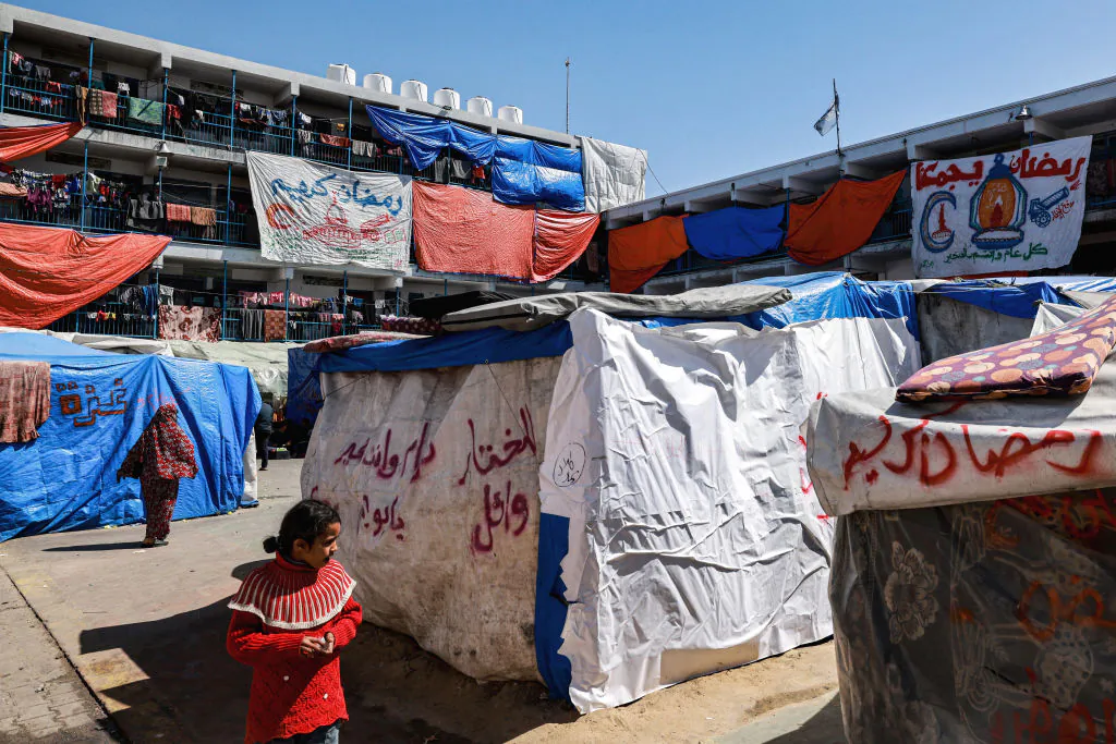 A camp sheltering displaced Palestinians erected in a school run by the United Nations Relief and Works Agency for Palestine Refugees (UNRWA) in Rafah in the southern Gaza Strip on March 13, 2024. (Mohammed Med Abed/AFP via Getty Images)