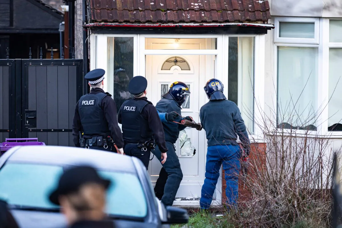Merseyside Police, operating during county lines intensification week, break down the door of a house in Liverpool, England, on March 4, 2024. (Merseyside Police) 