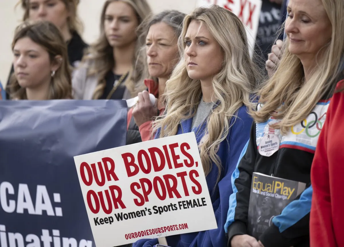 Former University of Kentucky swimmer Riley Gaines (2nd R) stands during a rally to protect women's sports outside of the NCAA Convention in San Antonio on Jan. 12, 2023. (Darren Abate/AP Photo)