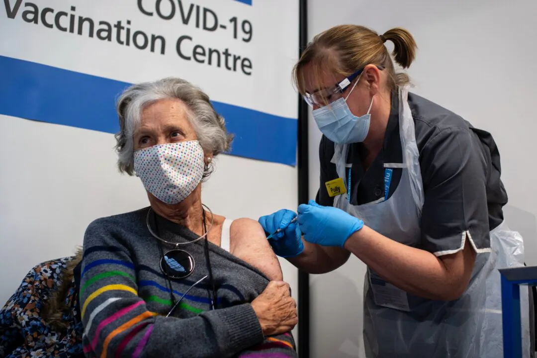 Doreen Brown, 85, receives the first of two Pfizer/BioNTech COVID-19 vaccine jabs at Guy's Hospital at the start of the largest ever immunisation programme in the UK's history, in London on Dec. 8, 2020. (Victoria Jones - Pool / Getty Images)
