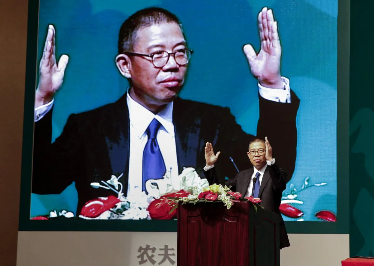 Zhong Shanshan, chairman of Nongfu Spring mineral water and a separate pharma company, gestures during a speech at a press conference in Beijing on May 6, 2013. (Str/CNS/AFP via Getty Images)