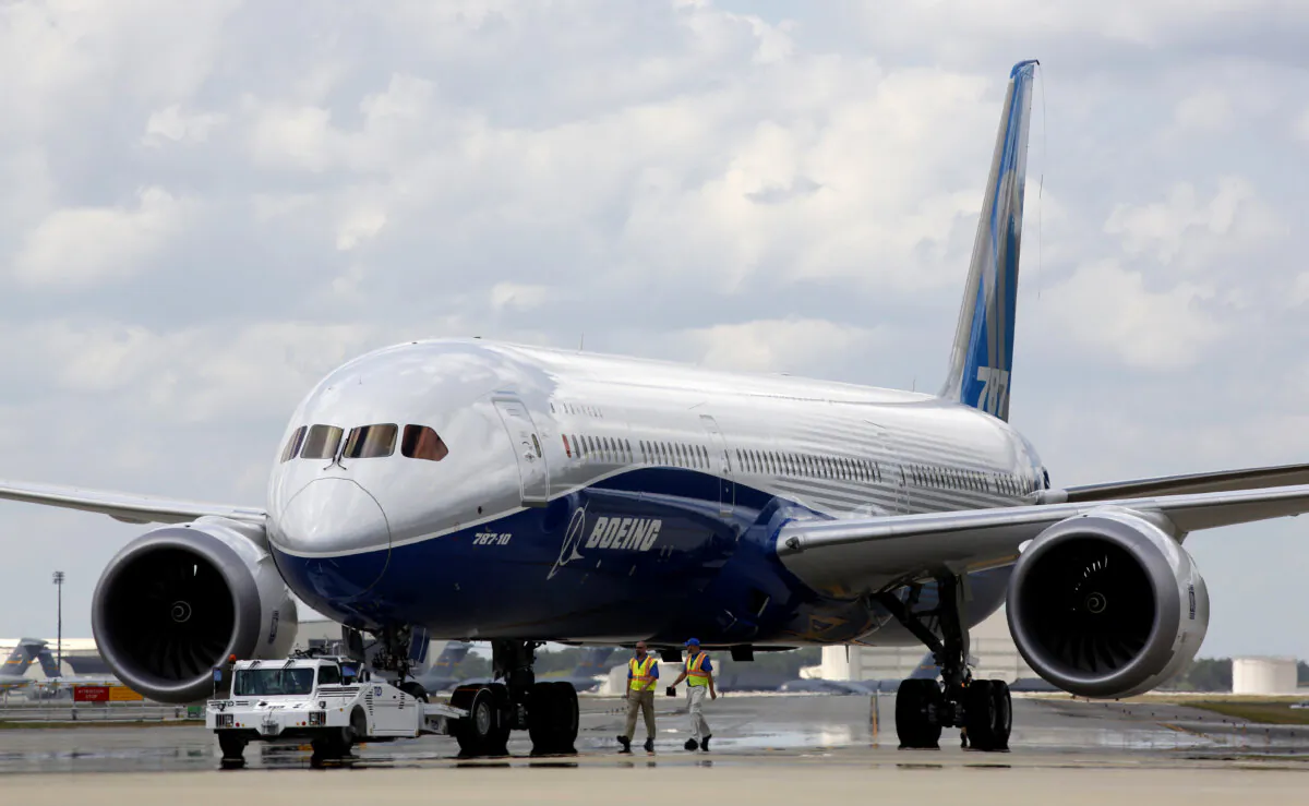 Boeing employees walk near the new Boeing 787-10 Dreamliner at the company's facility in South Carolina after conducting its first test flight at Charleston International Airport in North Charleston, S.C., on March 31, 2017. (Mic Smith/AP Photo)