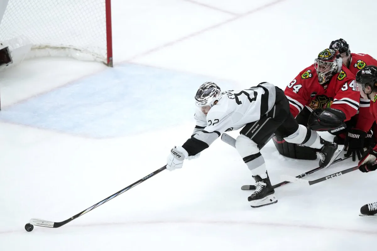 Los Angeles Kings' Kevin Fiala (L) is unable to get control of the puck as he skates past Chicago Blackhawks goaltender Petr Mrazek (34) during the second period of an NHL hockey game in Chicago March 15, 2024. (Charles Rex Arbogast/AP Photo)